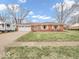 Charming brick ranch home features a two car garage, mature trees, and well maintained lawn at 504 Pelenor Dr, Franklin, IN 46131