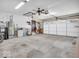 Spacious garage with ample storage, a functional door and a ceiling fan for ventilation at 504 Pelenor Dr, Franklin, IN 46131