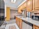 Well-lit kitchen featuring oak cabinetry, stainless steel appliances, and a seamless flow into the dining area at 504 Pelenor Dr, Franklin, IN 46131