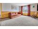 Cozy living room with plush carpet, vintage wallpaper, and large window providing lots of light at 504 Pelenor Dr, Franklin, IN 46131