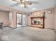 Bright living area showcasing a brick fireplace, access to the backyard, and ample space at 504 Pelenor Dr, Franklin, IN 46131