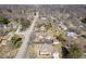 An aerial view of a residential area featuring neat lawns and mature trees, showcasing a peaceful community setting at 5055 Willow Rd, Zionsville, IN 46077