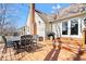 Backyard deck with outdoor dining set, grill, and access to the house through glass doors at 5055 Willow Rd, Zionsville, IN 46077