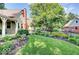 Beautifully landscaped backyard with green grass and colorful flower beds at 5055 Willow Rd, Zionsville, IN 46077
