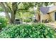 Inviting backyard featuring a wooden deck, lush greenery, and mature trees for outdoor enjoyment at 5055 Willow Rd, Zionsville, IN 46077