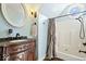 Classic bathroom with a vintage vanity, ornate mirror, and a shower-tub combination at 5055 Willow Rd, Zionsville, IN 46077
