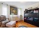 Cozy bedroom with hardwood floors, a decorative chair, and a large black storage unit at 5055 Willow Rd, Zionsville, IN 46077