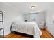 Light bedroom featuring hardwood floors and neutral walls at 5055 Willow Rd, Zionsville, IN 46077