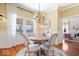 Charming dining room features hardwood floors, large windows, and modern decor at 5055 Willow Rd, Zionsville, IN 46077