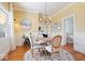 Elegant dining room featuring hardwood floors, chandelier lighting, and a view into a cozy sitting area at 5055 Willow Rd, Zionsville, IN 46077
