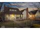Charming home featuring a red brick chimney, inviting front porch with seating, and well-kept landscaping at 5055 Willow Rd, Zionsville, IN 46077