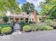 Charming home featuring a red brick chimney, inviting front porch, and lush landscaped yard at 5055 Willow Rd, Zionsville, IN 46077