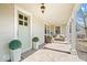 Inviting covered front porch with comfortable seating and charming architectural details at 5055 Willow Rd, Zionsville, IN 46077