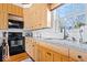 Well-lit kitchen featuring granite countertops, wooden cabinets, and stainless steel appliances at 5055 Willow Rd, Zionsville, IN 46077