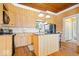 Well-lit kitchen boasting an island, wooden cabinets, and modern appliances at 5055 Willow Rd, Zionsville, IN 46077