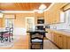 Bright kitchen featuring custom wood cabinets, granite countertops, and a cozy breakfast nook with natural lighting at 5055 Willow Rd, Zionsville, IN 46077