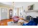 Bright living room showcasing hardwood floors, a fireplace, and charming decor at 5055 Willow Rd, Zionsville, IN 46077
