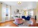Charming living room with hardwood floors, fireplace, and bright natural light from large windows at 5055 Willow Rd, Zionsville, IN 46077