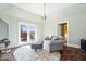 Cozy living room with french doors to the outdoor area, hardwood floors, and natural lighting at 5055 Willow Rd, Zionsville, IN 46077