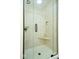 Glass shower with tiled walls, showerhead, and soap/shampoo shelf at 5055 Willow Rd, Zionsville, IN 46077