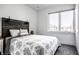 Inviting bedroom with neutral tones, a decorative headboard, and a window view at 606 E 10Th St, Indianapolis, IN 46202