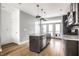 Open-concept kitchen with stainless steel appliances, granite countertops, and hardwood floors at 606 E 10Th St, Indianapolis, IN 46202