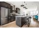 Chic kitchen with a spacious island featuring a stone countertop and stylish dark wood cabinets at 606 E 10Th St, Indianapolis, IN 46202