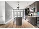 A spacious kitchen featuring stainless steel appliances, granite countertops, and a large island at 606 E 10Th St, Indianapolis, IN 46202