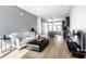 Inviting living room with hardwood floors, modern furniture, and an open layout leading to the kitchen at 606 E 10Th St, Indianapolis, IN 46202