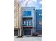 Close-up of a modern townhome with balcony and garage, showcasing its architectural details at 606 E 10Th St, Indianapolis, IN 46202