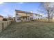Spacious backyard featuring a well-maintained lawn, wooden fence, and a charming deck with a pergola at 6311 Feather Run Dr, Indianapolis, IN 46237