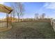 A backyard featuring a wooden deck with pergola and a spacious yard at 6311 Feather Run Dr, Indianapolis, IN 46237