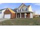 Lovely home with a brick and siding exterior, attached garage, and a covered front porch at 6311 Feather Run Dr, Indianapolis, IN 46237