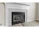 Close-up of a fireplace with a decorative mantle and a stylish tile surround at 6311 Feather Run Dr, Indianapolis, IN 46237