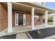 Welcoming front porch with white columns, brick accents, and a stylish black front door at 6311 Feather Run Dr, Indianapolis, IN 46237