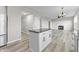 Bright kitchen with white cabinets, an island with a black countertop, and an open floor plan at 6311 Feather Run Dr, Indianapolis, IN 46237