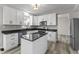 Bright kitchen features white cabinets, black countertops, stainless appliances, and a center island at 6311 Feather Run Dr, Indianapolis, IN 46237