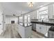 Modern kitchen with island, stainless steel appliances, and views into living area with fireplace at 6311 Feather Run Dr, Indianapolis, IN 46237