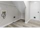 Bright laundry room with vinyl flooring, utility sink, and access to an exterior door at 6311 Feather Run Dr, Indianapolis, IN 46237
