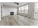 Inviting living room with a fireplace, hardwood floors, and plenty of natural light at 6311 Feather Run Dr, Indianapolis, IN 46237