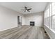 Spacious living room with hardwood floors, a fireplace, and large windows for ample light at 6311 Feather Run Dr, Indianapolis, IN 46237