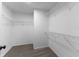 A walk-in closet provides ample storage space with wire shelving and neutral carpet at 6311 Feather Run Dr, Indianapolis, IN 46237