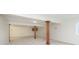 Unfinished basement with carpeted floors, wooden pillars, and neutral walls, offering potential for customization at 6333 Silver Moon Ct, Indianapolis, IN 46259