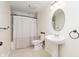 Bathroom featuring a pedestal sink, oval mirror, tiled shower-tub combo with neutral color scheme at 6333 Silver Moon Ct, Indianapolis, IN 46259