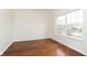 Bright, minimalist bedroom with hardwood floors and a large window letting in natural light at 6333 Silver Moon Ct, Indianapolis, IN 46259