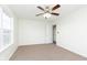 Bedroom with carpet, ceiling fan, and an open doorway to the en suite bathroom at 6333 Silver Moon Ct, Indianapolis, IN 46259