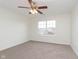 Spacious bedroom featuring carpet, a ceiling fan, and a large window for natural light at 6333 Silver Moon Ct, Indianapolis, IN 46259