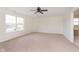 Large bright carpeted bedroom featuring a ceiling fan and large window at 6333 Silver Moon Ct, Indianapolis, IN 46259