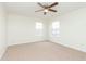 Carpeted bedroom featuring a ceiling fan and multiple windows for an abundance of light at 6333 Silver Moon Ct, Indianapolis, IN 46259