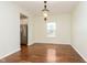Formal dining room with hardwood floors, a pendant light, and a view into the kitchen at 6333 Silver Moon Ct, Indianapolis, IN 46259